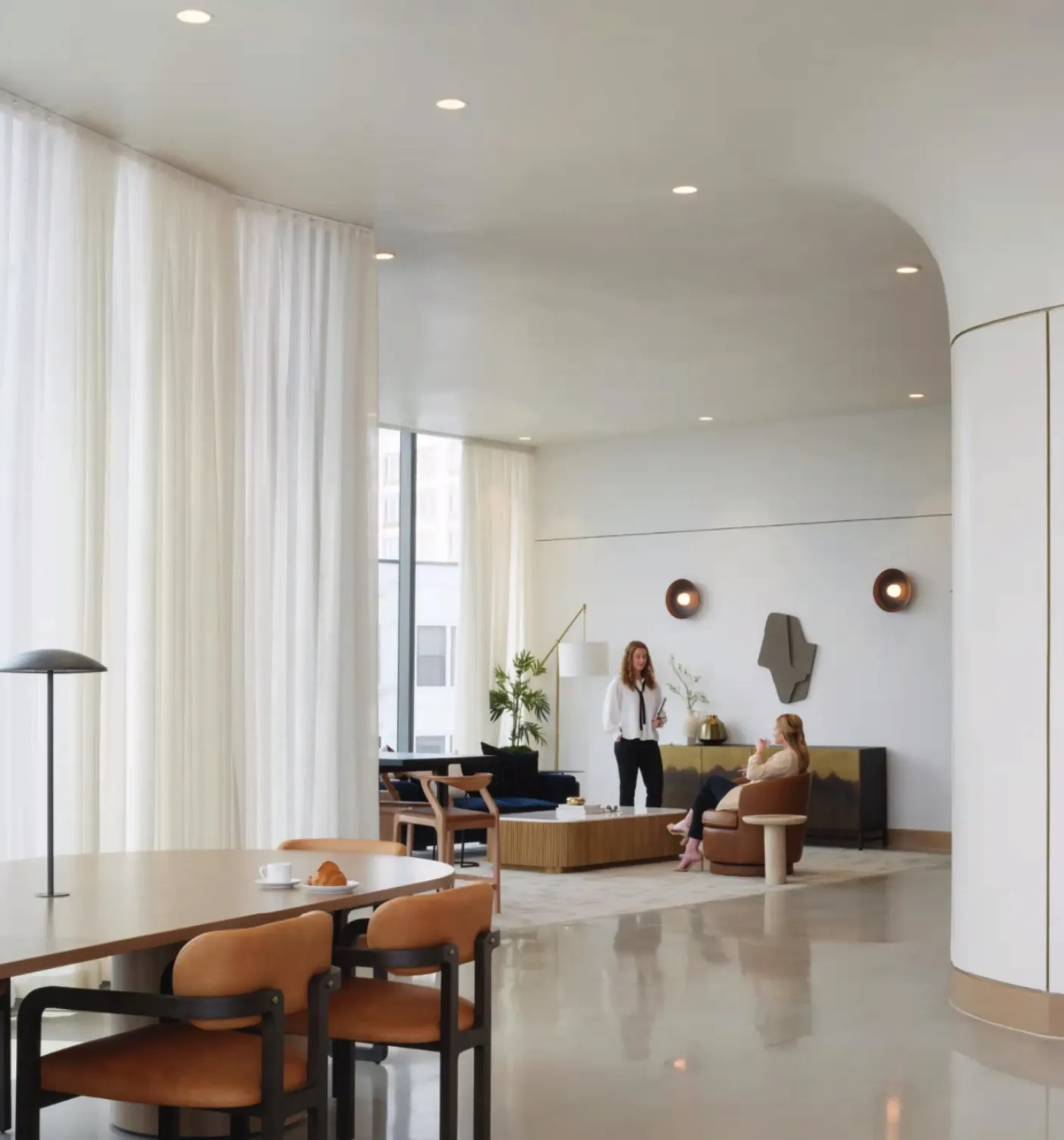 Lobby seating beneath a curved white ceiling